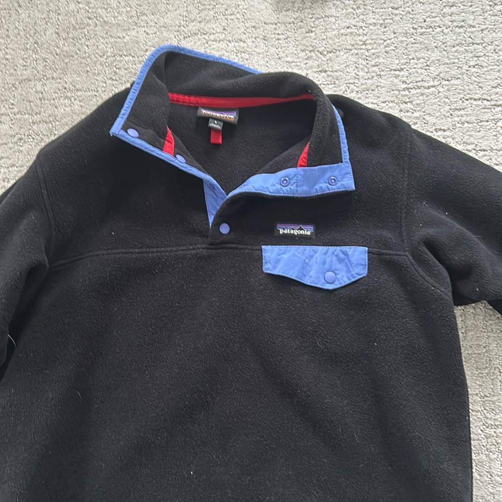 Like new Patagonia fleece pull over jacket.  Black with purple/blue accents.